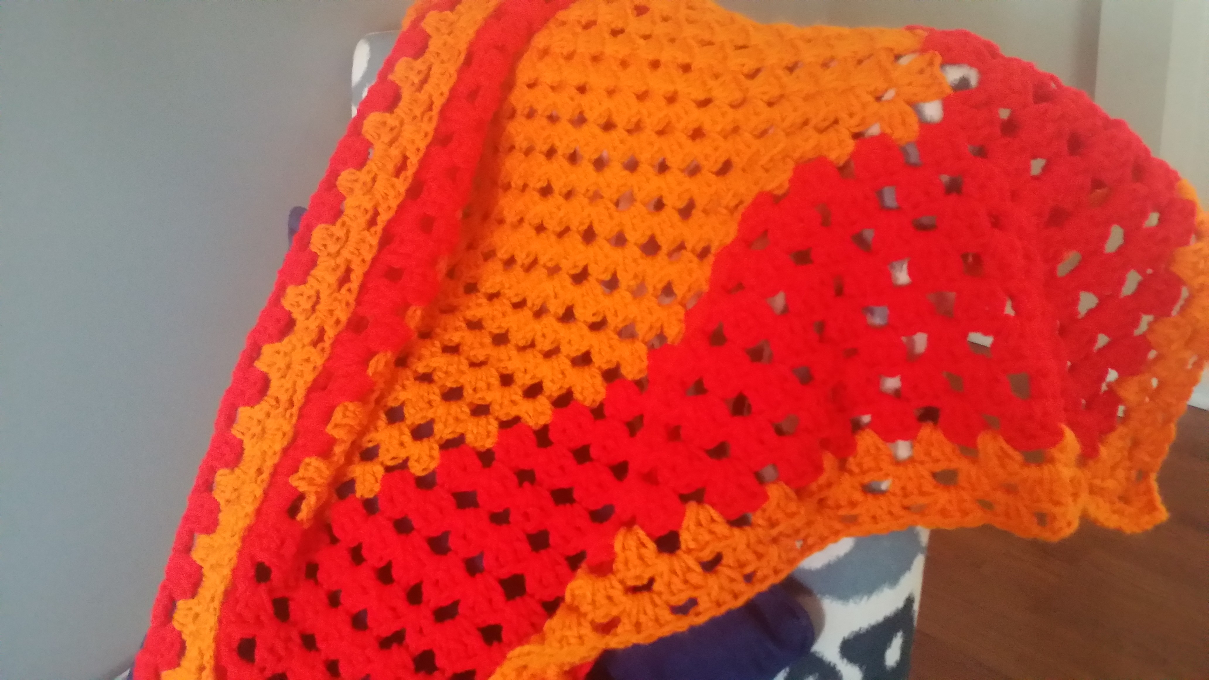 Orange and red granny square throw blanket